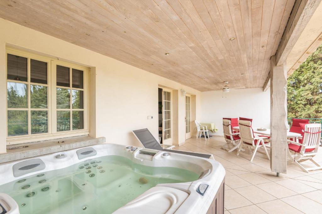 Terrasse équipée d’un jacuzzi avec vue sur le jardin
